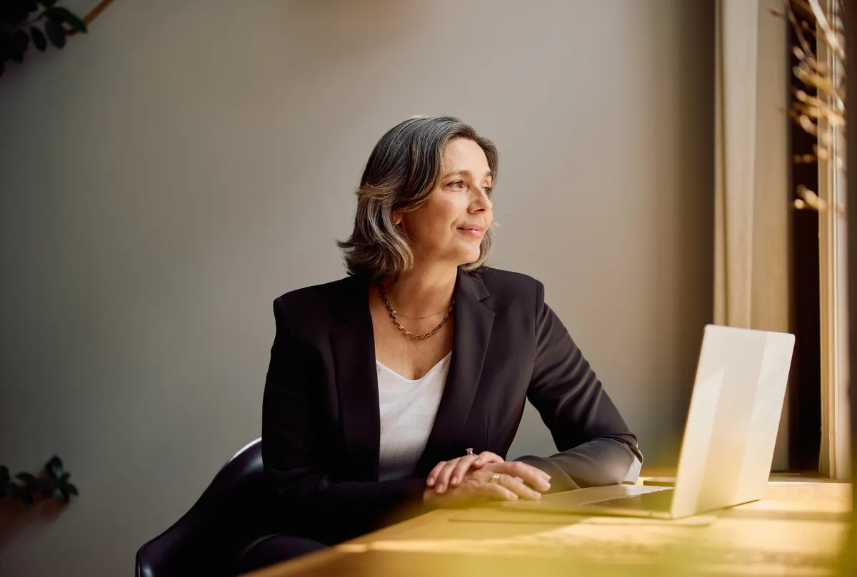 An IT leader reviewing endpoint strategy at a laptop by a window